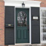 Traditional wood with glass front entry door in green