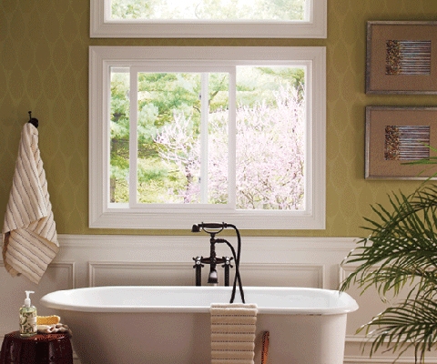 White sliding window in bathroom above bathtub