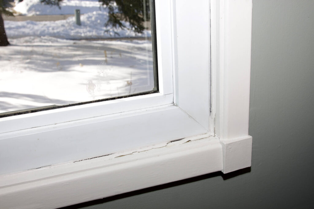 window with deteriorating and broken caulk seal