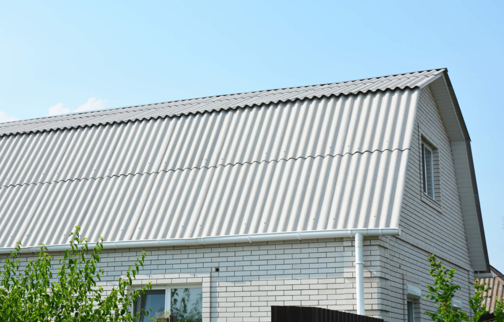 A gambrel roof on a white brick country home