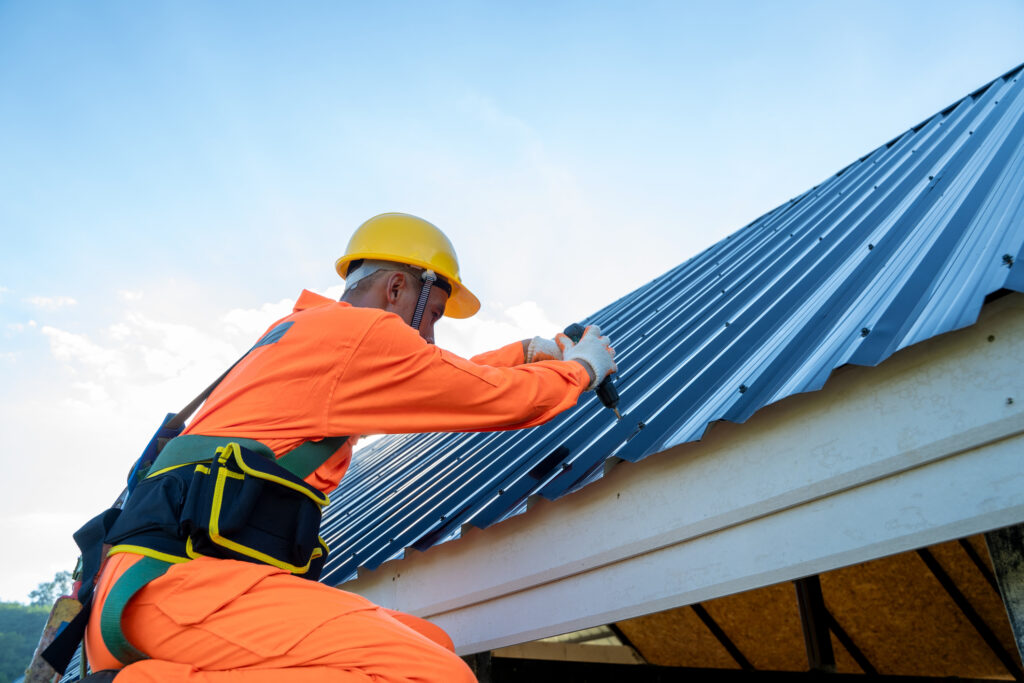 contractor installing a metal roof on residential home